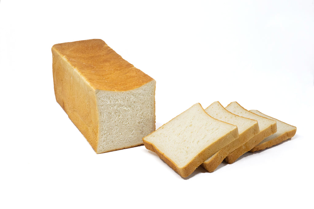 Photo of white bread loaf sliced